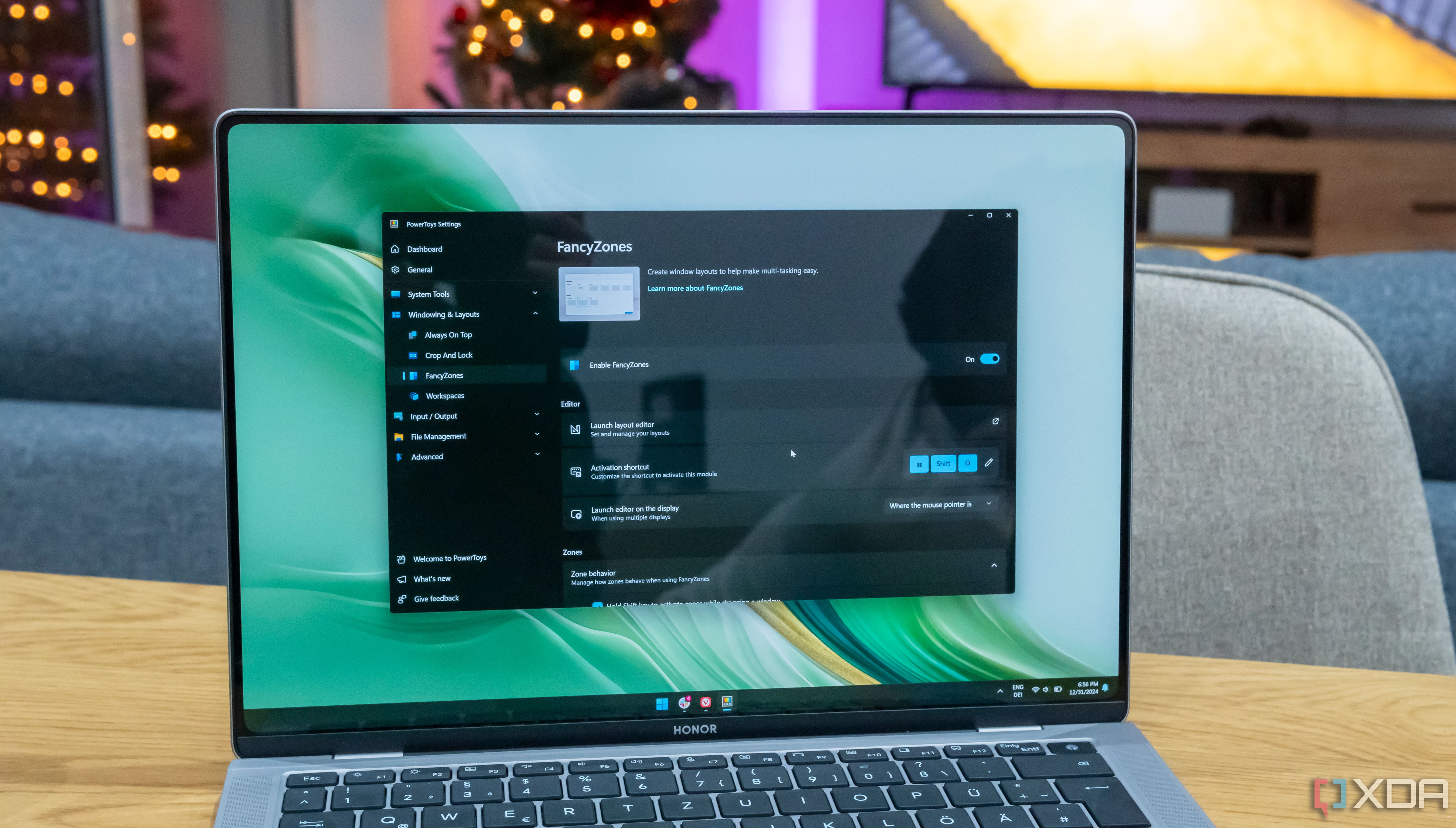 A Windows 11 laptop running PowerToys with the FancyZones settings page open