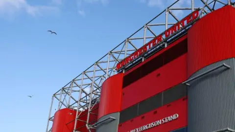 Reuters A view from outside Old Trafford stadium. A red sign at the top of the stadium reads 'Manchester United'. 