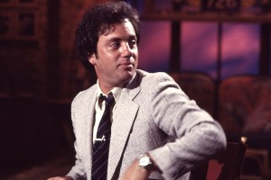View of American Pop musician Billy Joel as he sits in a director's chair during an interview at MTV Studios, New York, New York, September 29, 1982. (Photo by Gary Gershoff/Getty Images)