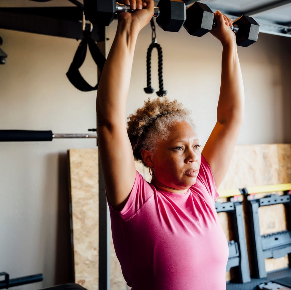 black couple lifting working out in garage
