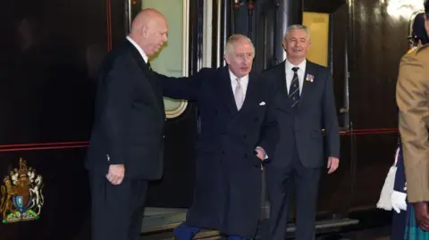Getty Images King Charles is seen exiting the royal train in 2023