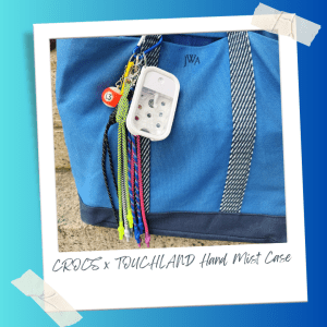 WWD shopping director Adam Mansuroglu totes the new Crocs x Touchland Hand Mist Case bag charm to work. 