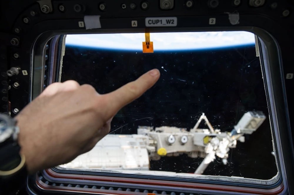 Orbital Debris strike on one of the window’s within the International Space Station. (Credit : NASA)