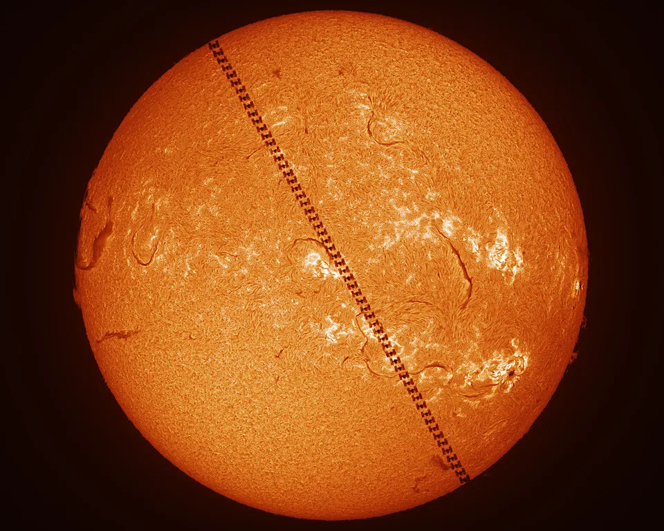 a time-lapse of a space craft passing in front of the sun