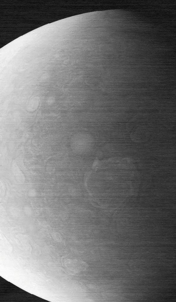 JunoCam captured this image of Jupiter on Nov. 22, 2023. It shows a circumpolar cyclone on Jupiter's north pole, but the image is grainy and corrupted with horizontal lines. Image Credit: NASA/JPL-Caltech/SwRI/MSSS