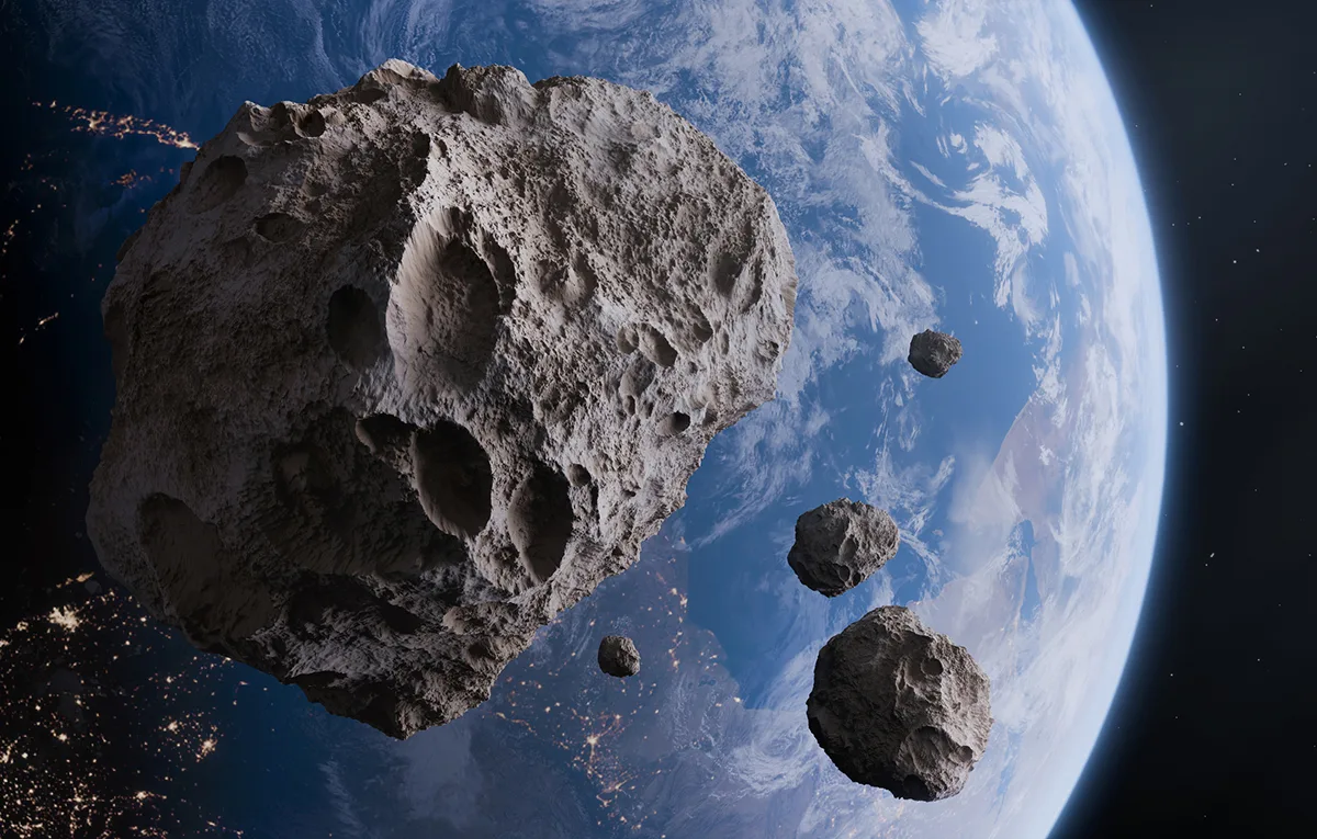 Earth and asteroids. Credit: Mikdam/Getty