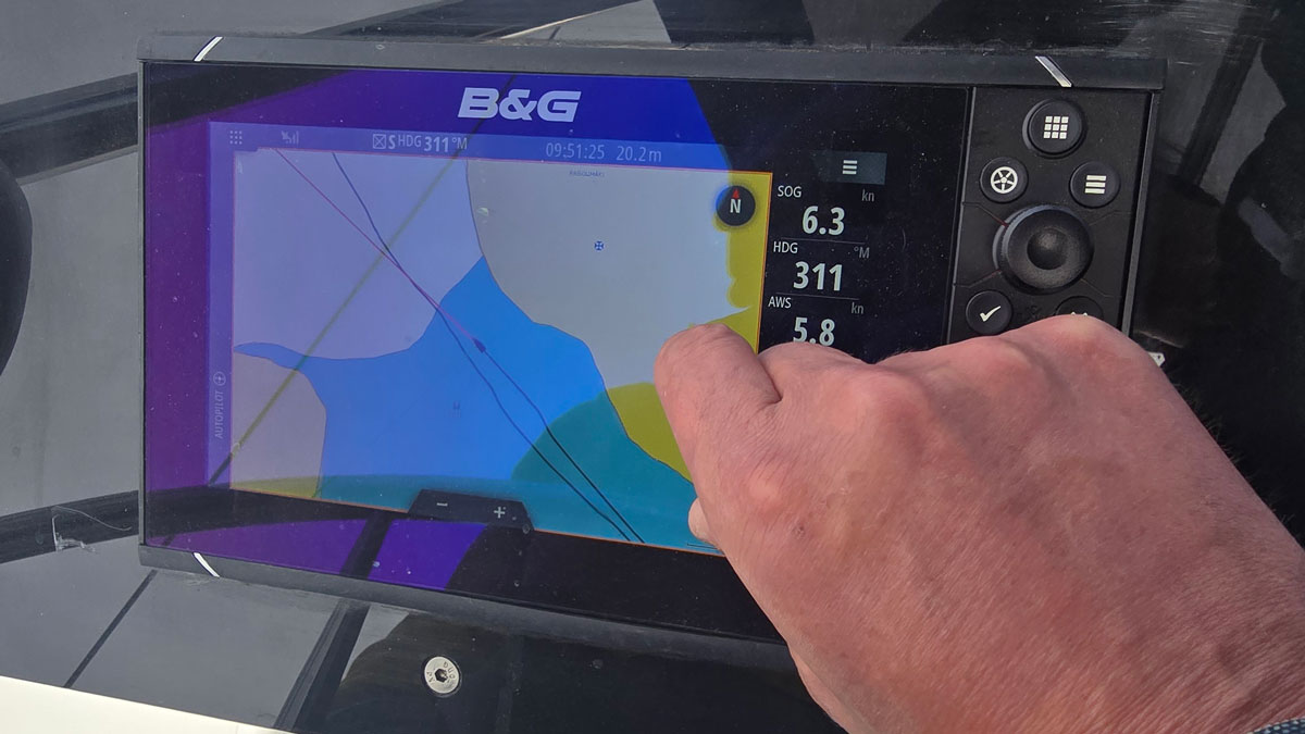 A person using a chartplotter on a boat