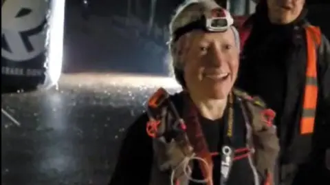 Anna Rutherford Anna after crossing the finish line. She has a head torch on her head