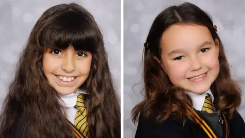 Family photos Two images of Alice Aguiar and Bebe King sit side by side. The girls are smiling and wearing their school uniform, which is a black jacket with a yellow-and-black striped tie. 