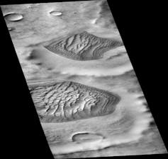 A black and white aerial images of dune fields on Mars.