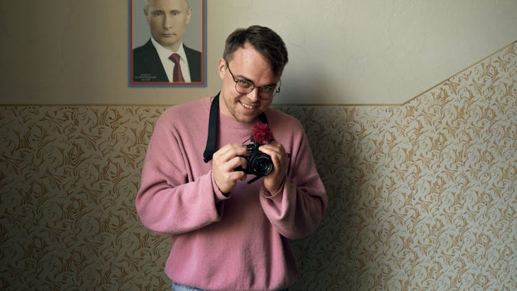 Pavel Talankin holding a camera