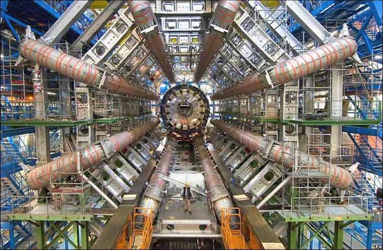 A large array of machinery arranged in a tunnel, as part of a particle detector experiment.