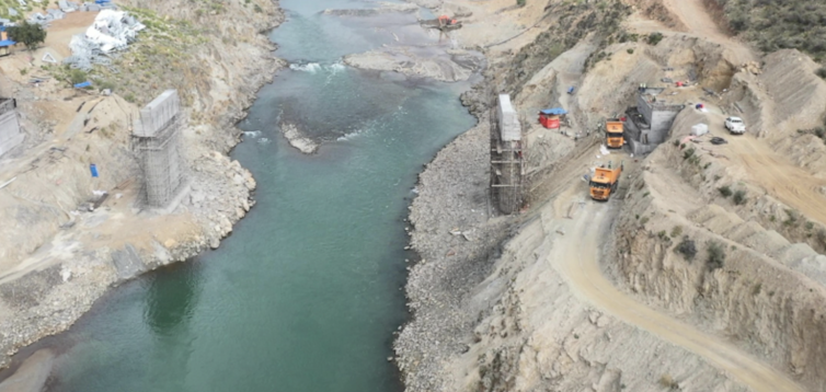 Two foundation stones are seen either side of a river.