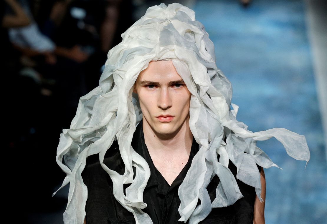 A model wears a fabric wig at the Yohji Yamamoto show. The Japanese designer offered a closing statement after taking his bow at the end of the catwalk: “Human beings,” he said, need to come together “without making war. And politicians need to be more clever. Otherwise, the world will end too soon.”