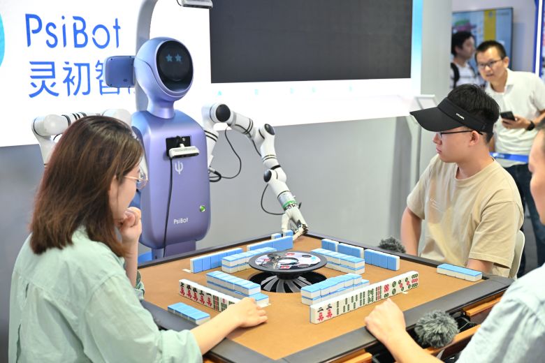 A PsiBot robot plays mahjong during the 2025 World AI Conference (WAIC) and High-Level Meeting on Global AI Governance at Shanghai World Expo Exhibition and Convention Center in Shanghai, on July 27, 2025.