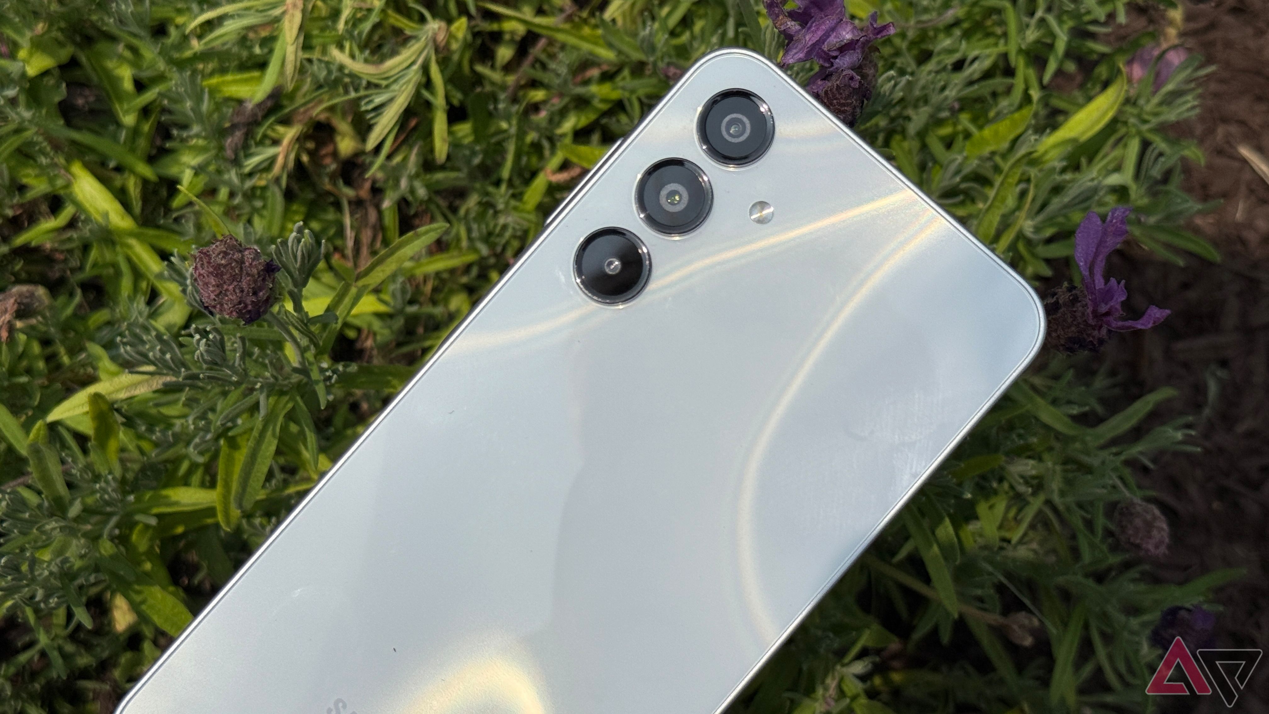Samsung Galaxy A16 in sunlight with flowers behind