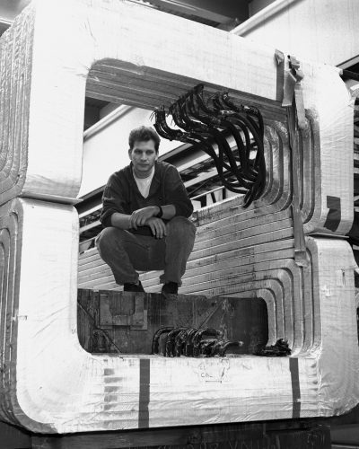 In 1986, Vittorio Paolone poses inside the magnet used to eliminate charged particles from the neutrino beam. Credit: Reidar Hahn, Fermilab
