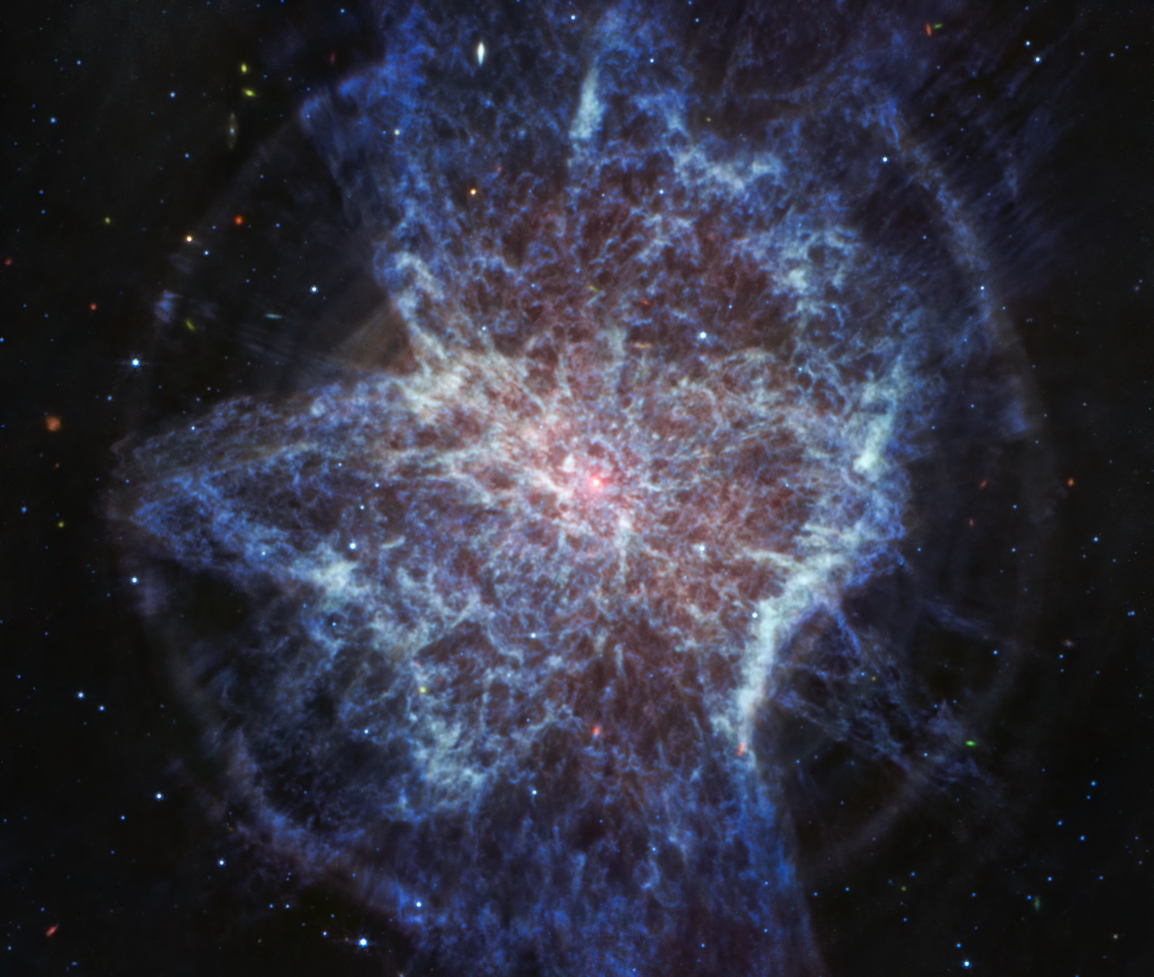 Streaks of blue dust and gas gleam in the darkness of outer space
