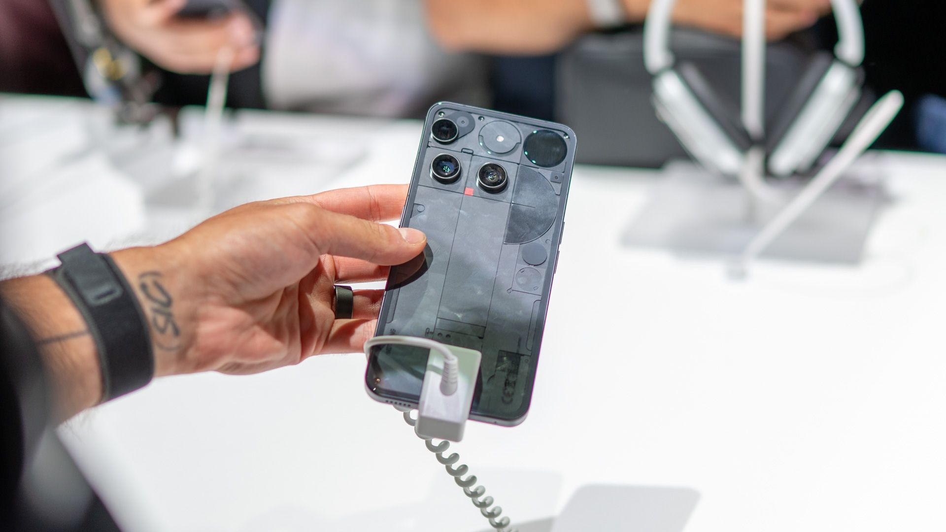 Person holding the Nothing Phone 3, showing the back of the phone.