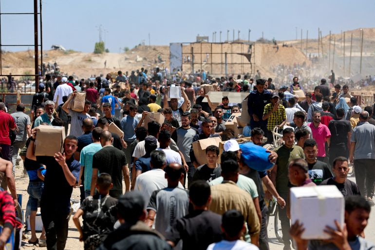 Palestinians carry aid supplies