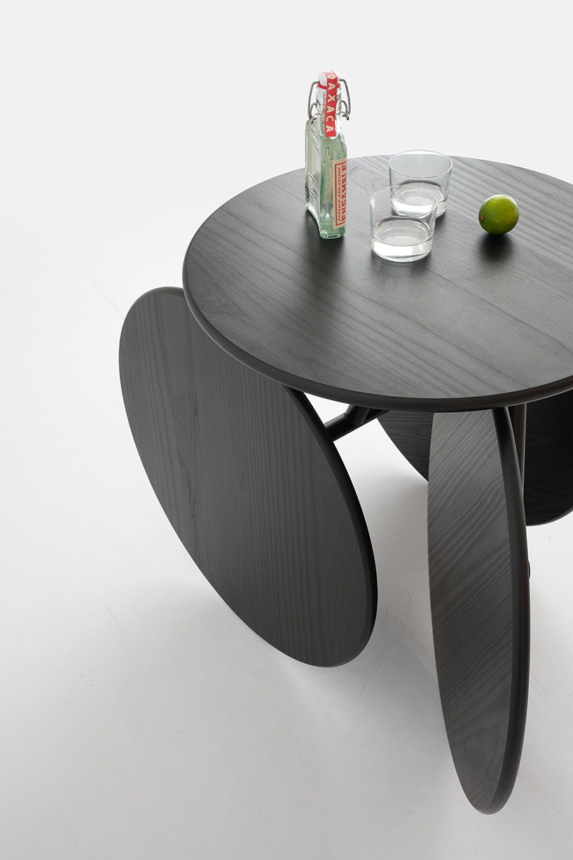four identical wooden circles sculpt rolling table by mike & maaike