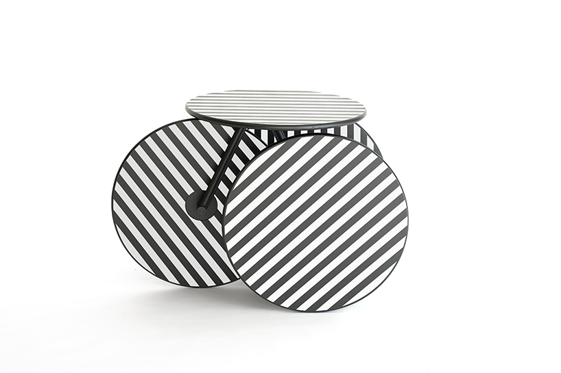 four identical wooden circles sculpt rolling table by mike & maaike