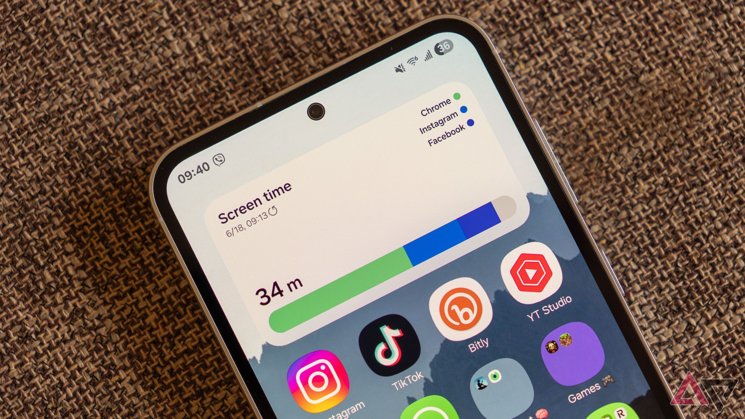 a close up of a samsung galaxy phone displaying the screen time widget and home screen icons