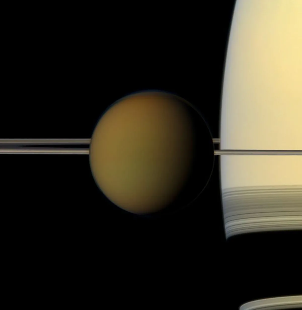 Titan passes in front of Saturn in an image from NASA's Cassini spacecraft. Credit: NASA/JPL-Caltech/Space Science Institute