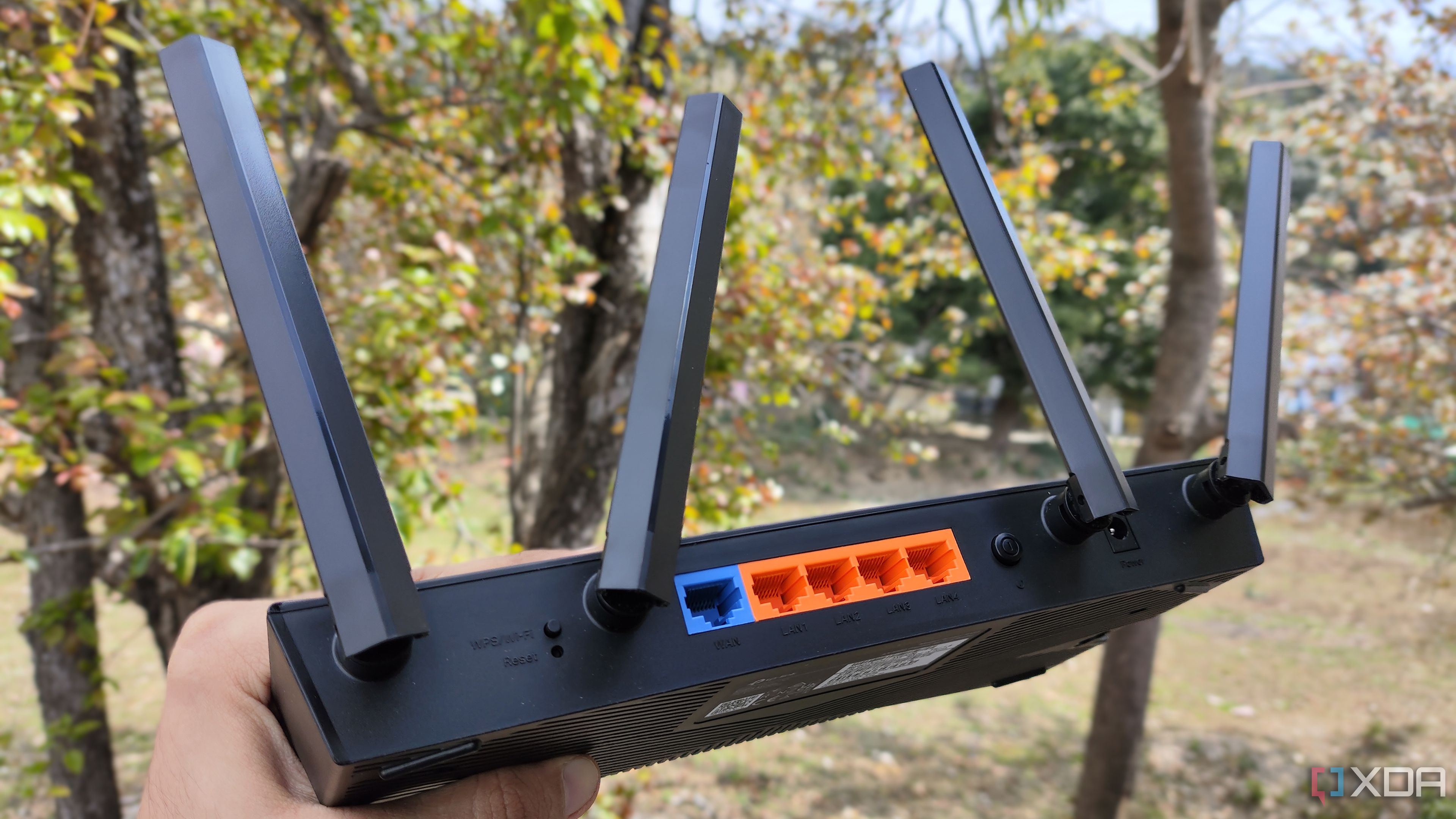 A person holding a TP-Link router