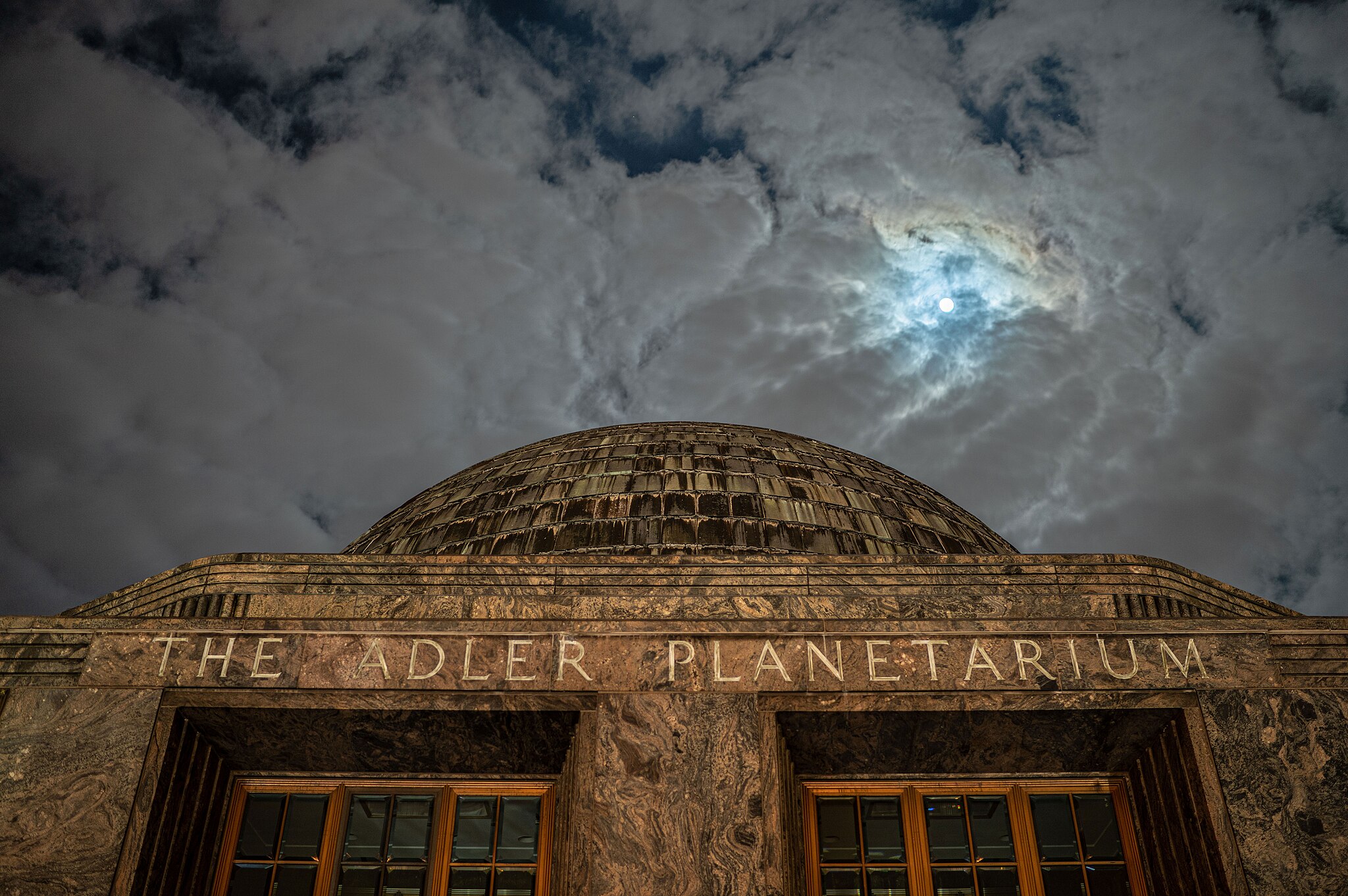 A golden building in front of gray skies