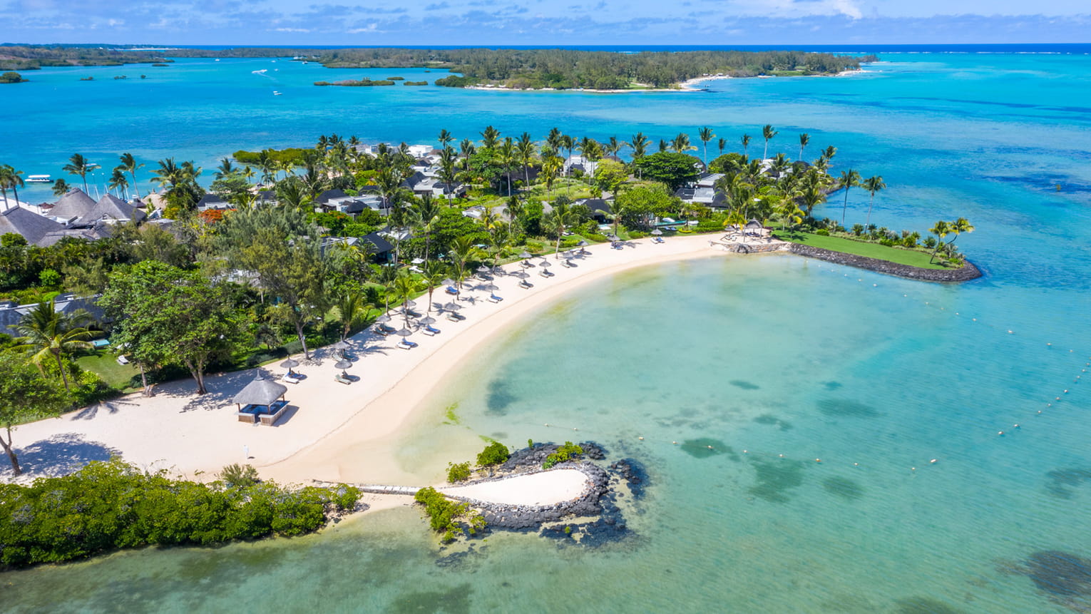 Aerial view of Four Seasons Mauritius resort beach and ocean.
