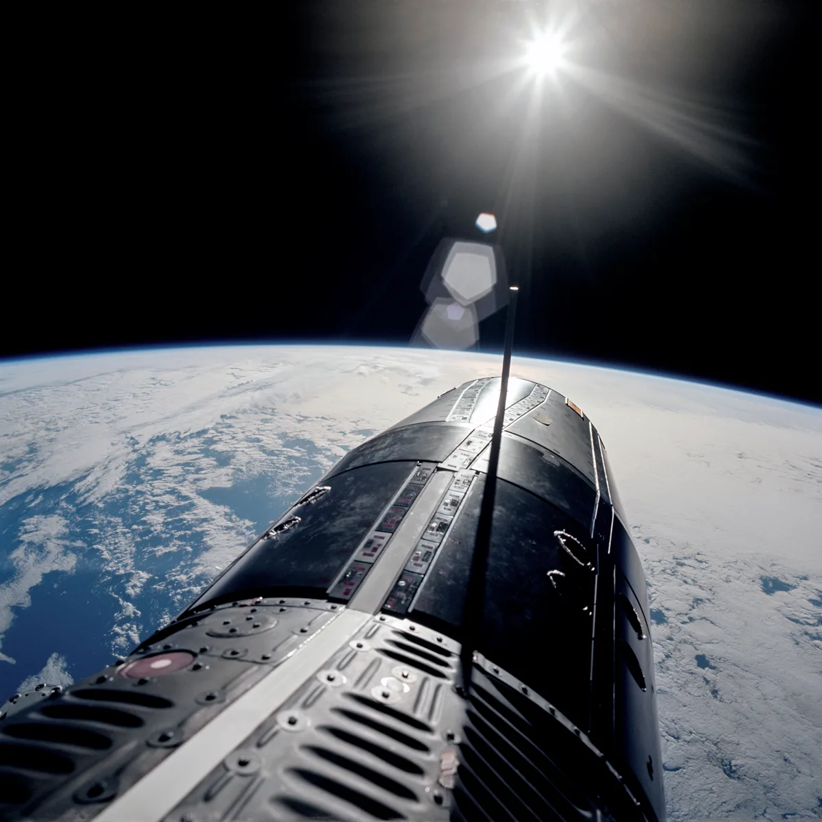 The rudimentary-looking Gemini spacecraft, Earth, and the bright, white sunlight captured during a spacewalk by Gene Cernan on Gemini 9A. 5th June, 1966. Credit NASA / ASU / Andy Saunders