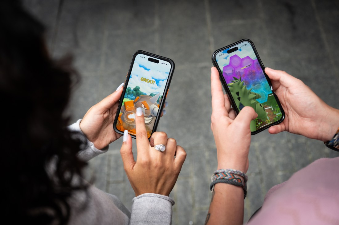 Two people having a Pokemon battle on their phones.