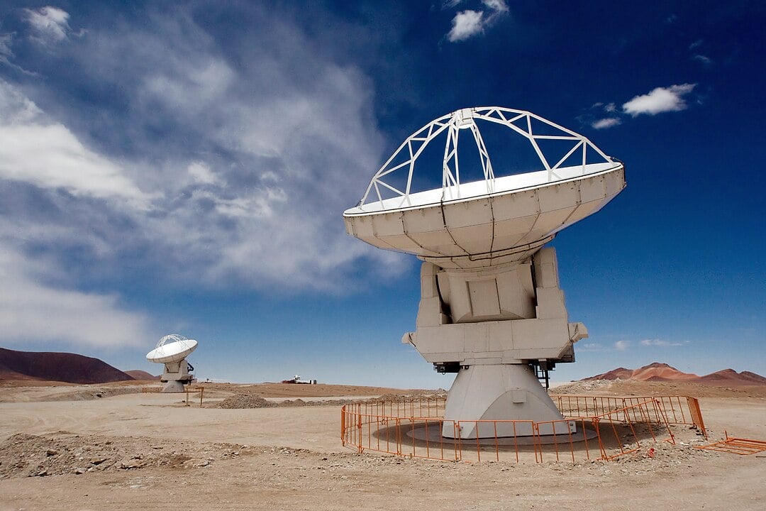 Two of the Atacama Large Millimeter/submillimeter Array (ALMA) 12-metre antennas gaze at the sky at the observatory’s Array Operations Site (AOS), high on the Chajnantor plateau at an altitude of 5000 metres in the Chilean Andes (Credit : Iztok Bončina/ESO)