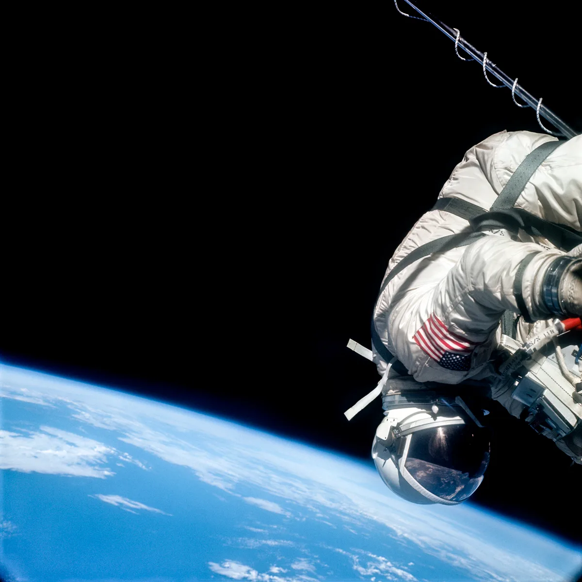 Buzz Aldrin is seen clinging to the spacecraft during his spacewalk as he orbits Earth at over 17,000mph on Gemini 12, 13th November, 1966. Credit NASA / ASU / Andy Saunders