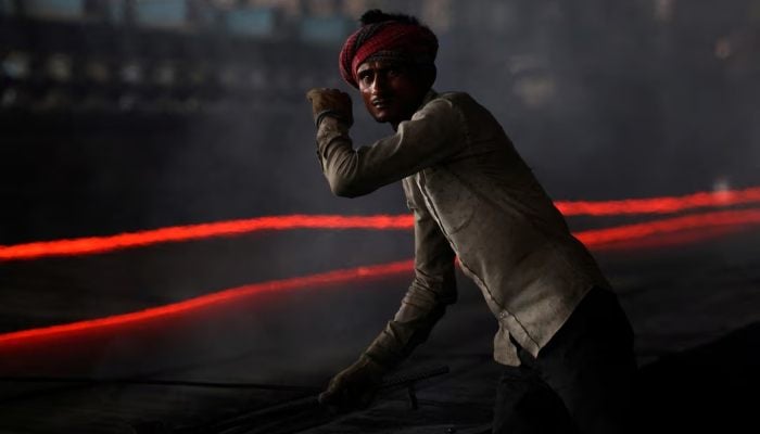 A worker gestures as he works at a steel processing production line of a factory in Mandi Gobindgarh, in the northern state of Punjab, India, August 14, 2025. — Reuters