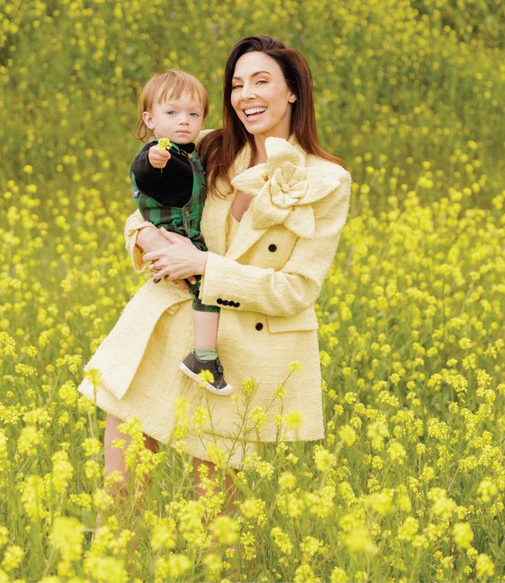 Cummings smiling and holding her son at home in Los Angeles.