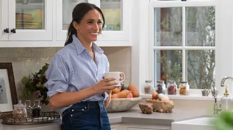 Netflix A picture of Meghan standing in a kitchen