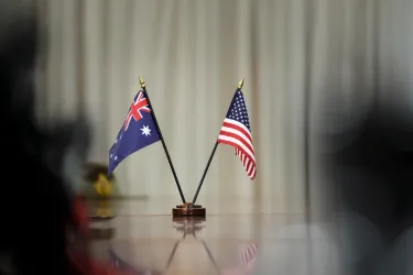 A US and Australian flag in a small stand on a table