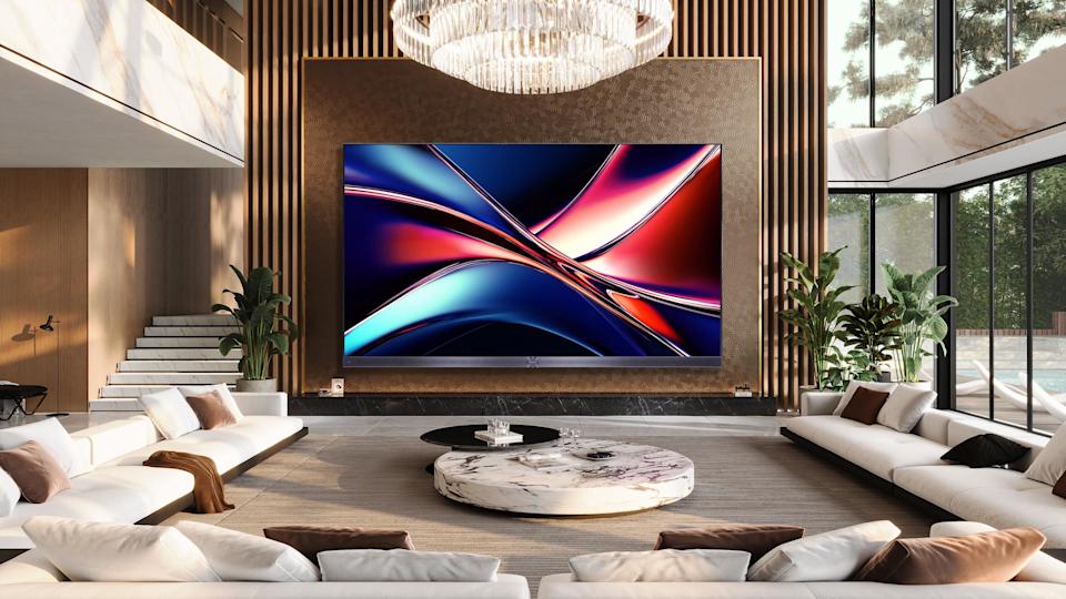 A gigantic 136-inch Hisense MicroLED TV mounted on a wall.