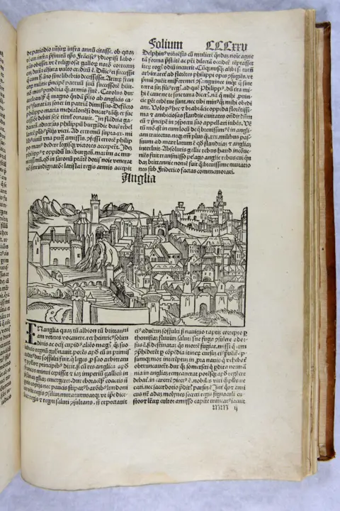 Ushaw A page in the Nuremberg Chronicle with an illustration of a town across the centre and two columns of writing above and below.