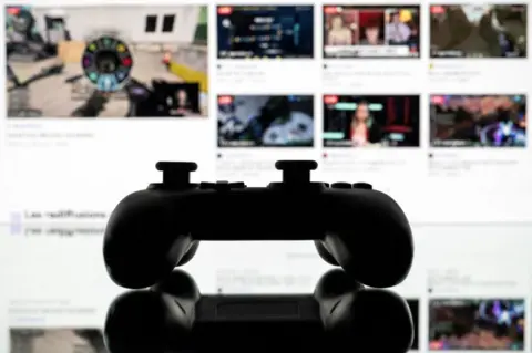 Getty Images A games console controller backlit by a screen showing a Twitch profile