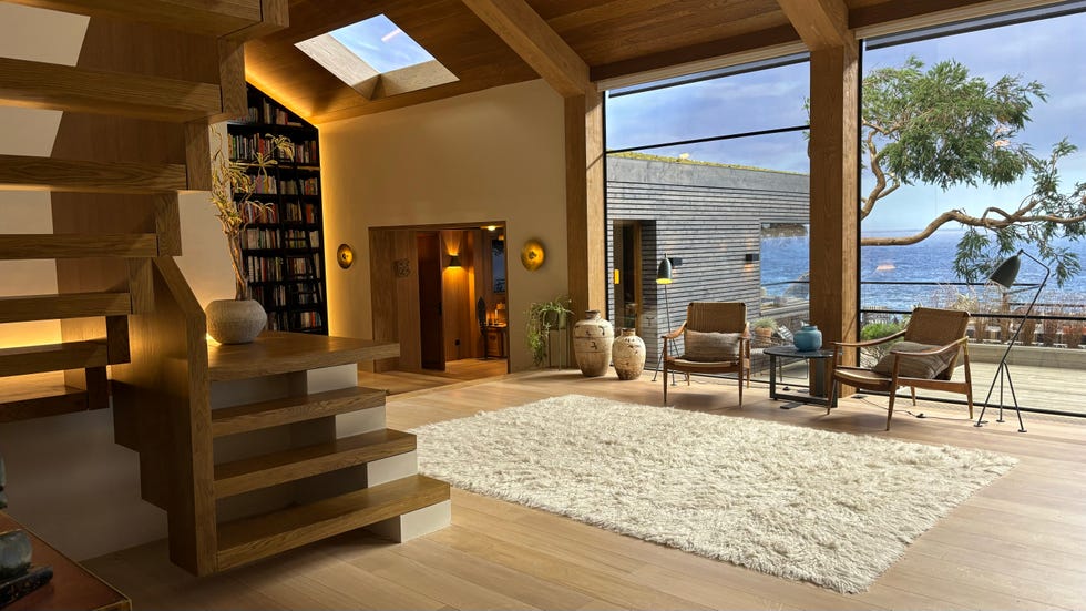 Modern living room with ocean view and wooden details.