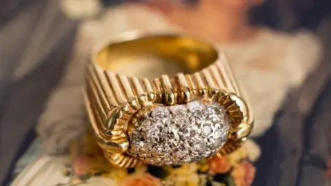 Bearnes Hampton  & Littlewood An 18ct gold diamond ring, the domed white metal centrepiece is pavé set with twenty-seven single-cut diamonds of slightly varying size.