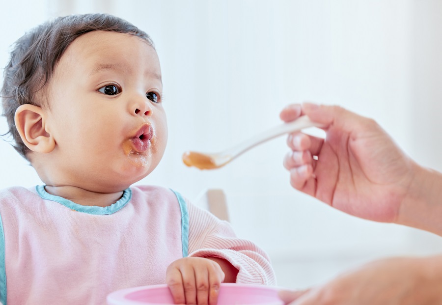 Infant being fed baby food