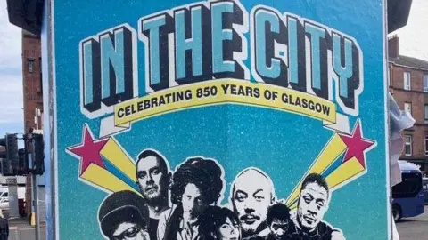 Sharon McMahon A blue event poster which reads 'In the city' celebrating 850 years of Glasgow.