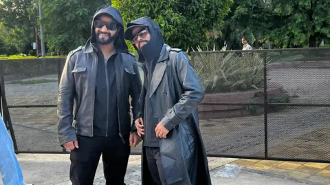 Anshul Verma Fans dressed like Reshammiya - in black jackets, shades and caps - pose for a photo at his Delhi concert