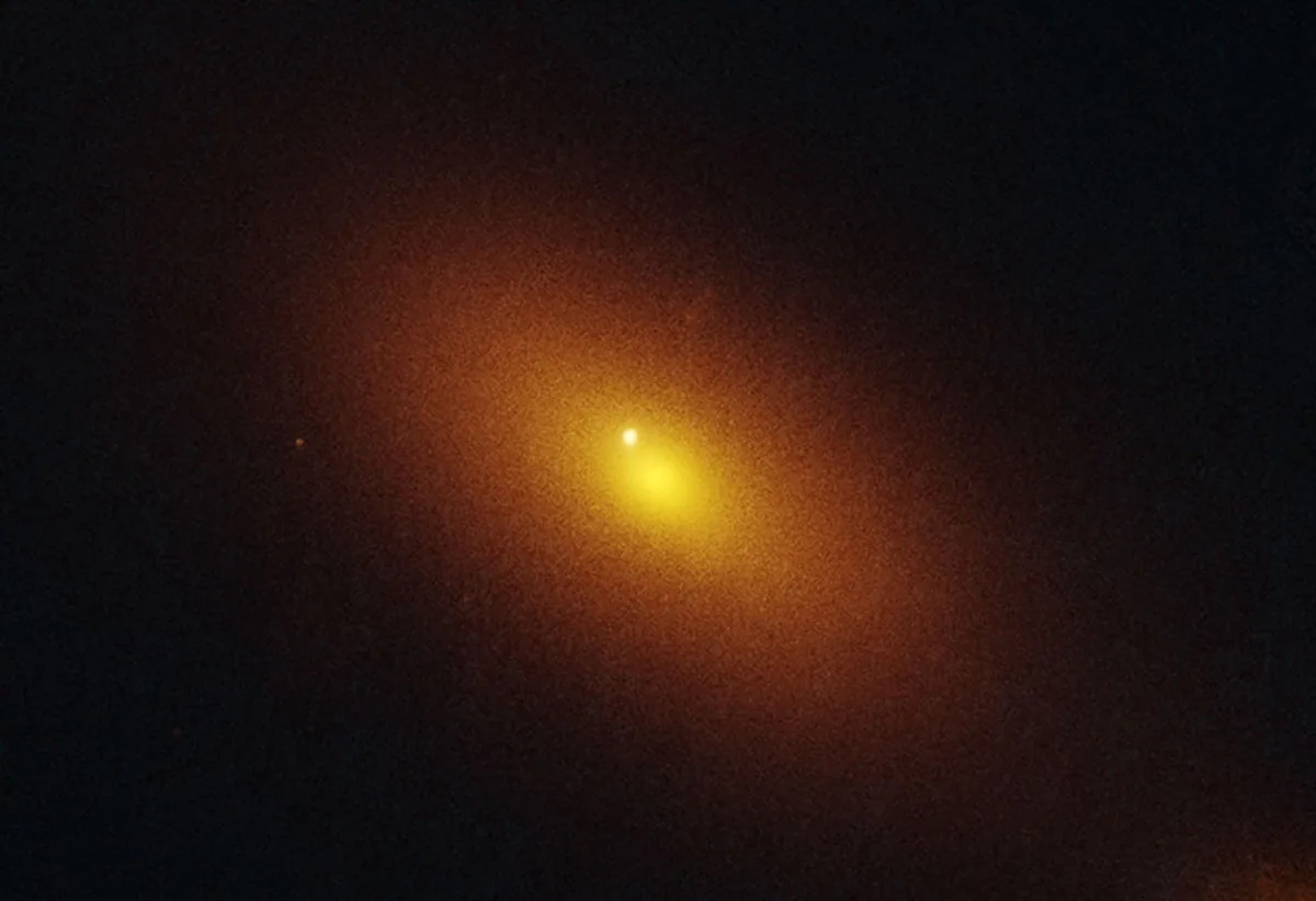 Hubble Space Telescope image of galaxy located 600 million light-years away that is host to the telltale signature of a roaming supermassive black hole. The bright dot is tidal disruption event AT2024tvd, a flash of radiation caused by the supermassive black hole eating a star. Credit: NASA, ESA, STScI, Yuhan Yao (UC Berkeley); Image Processing: Joseph DePasquale (STScI)