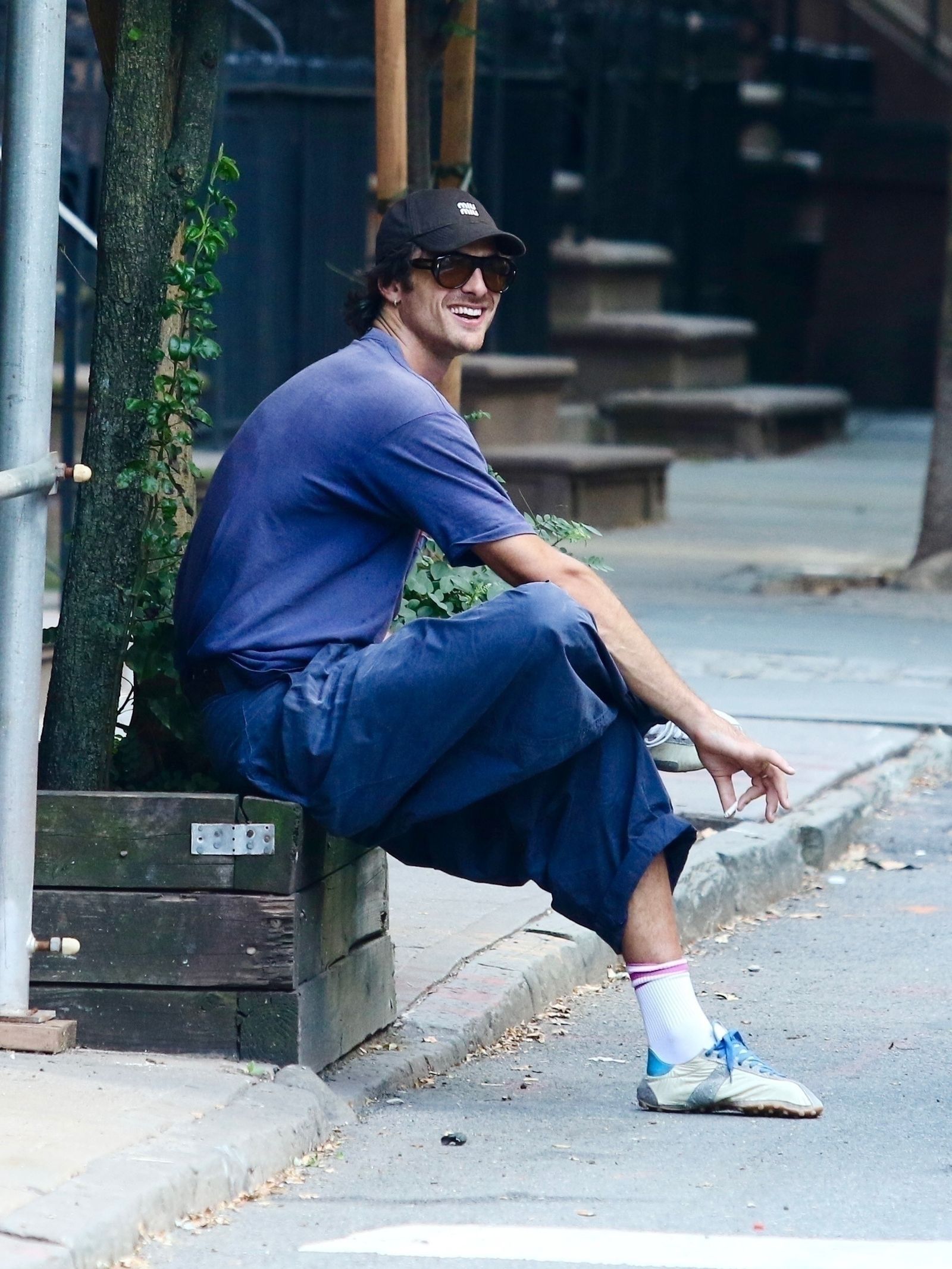 Image may contain Race Owen Person Sitting Clothing Hat Adult Footwear Shoe Accessories Glasses City and Road