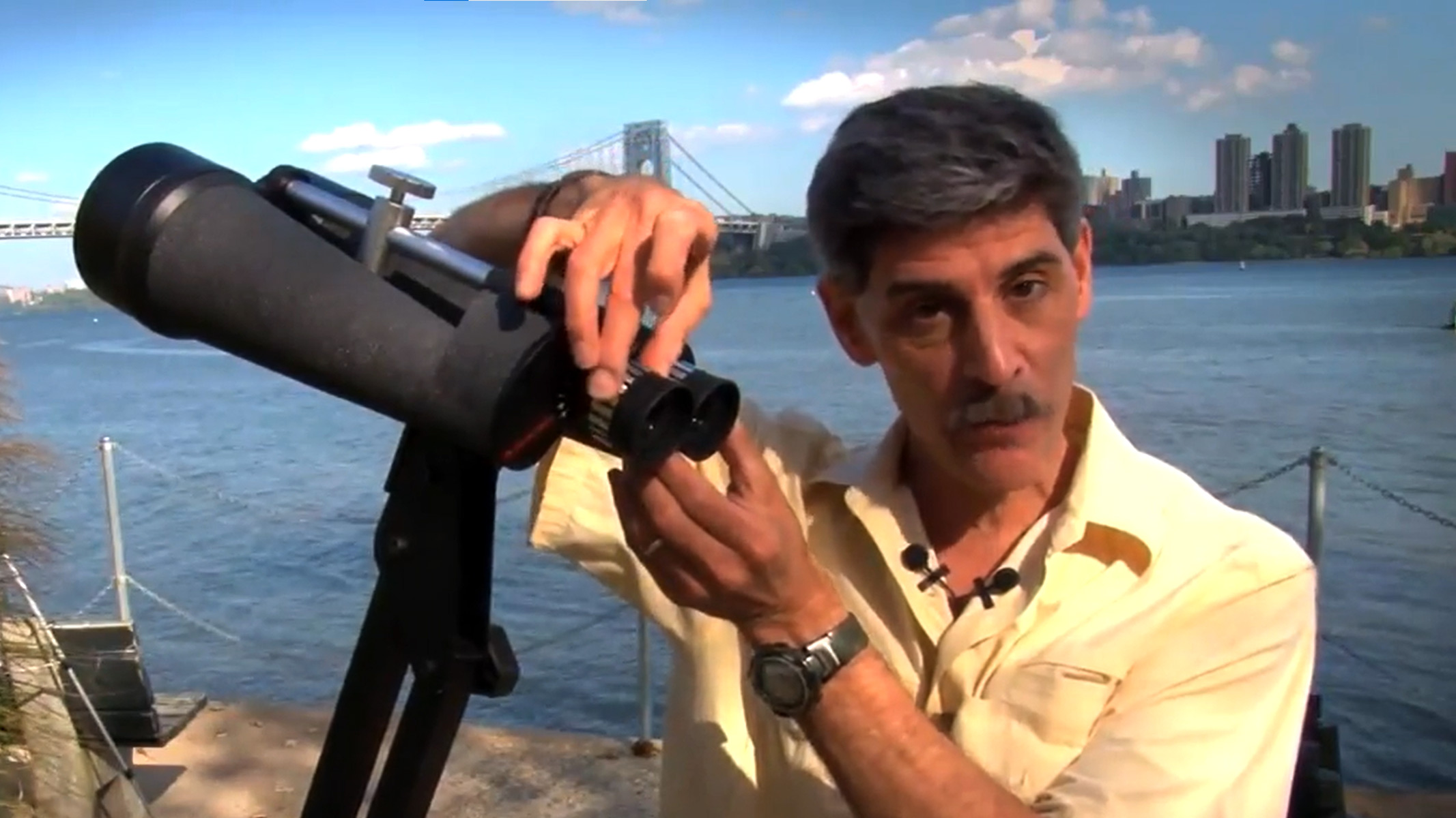 Celestron Skymaster 25x100 binoculars being handled on a tripod